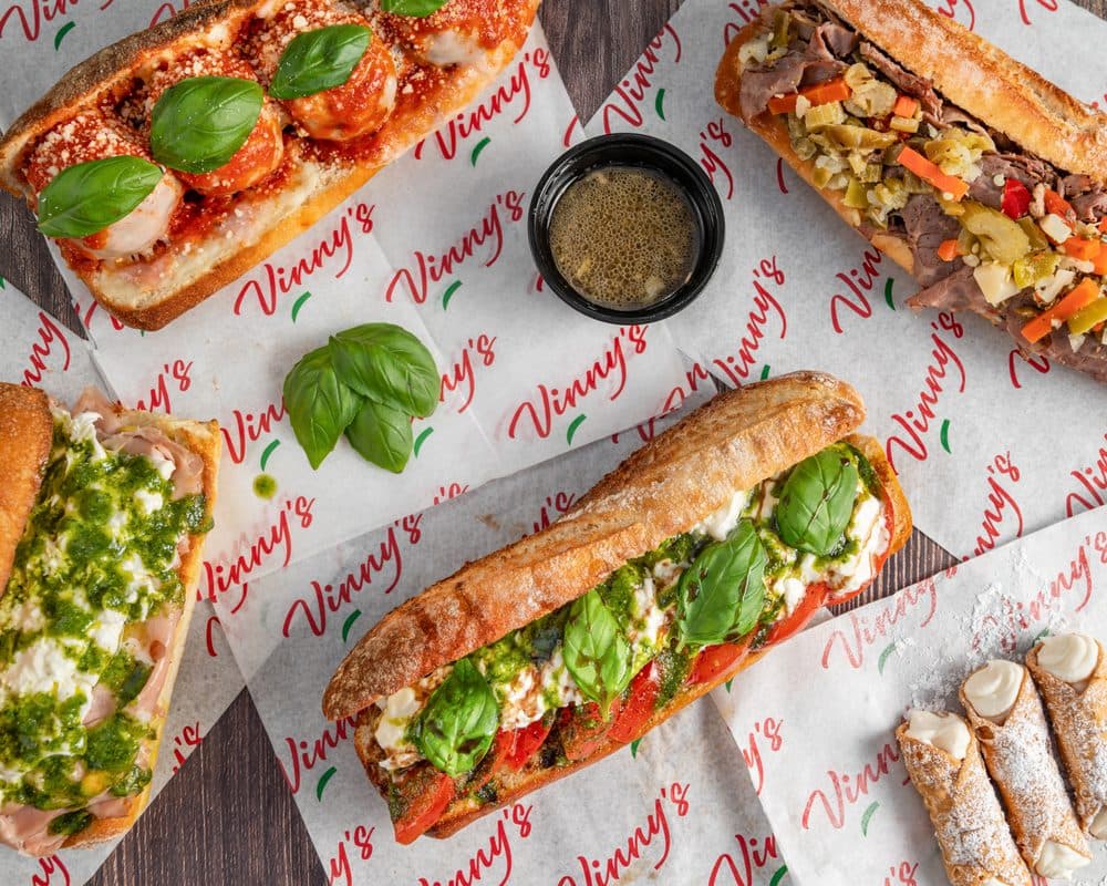 Vinny's sandwiches on branded paper, meatball sub, Italian beef and cannoli